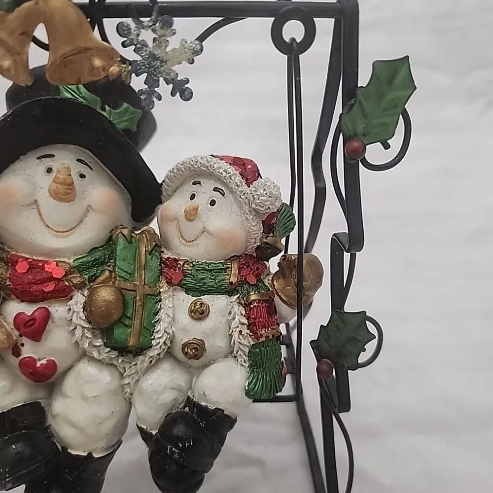 Swinging Snowman Couple Adorned With Glitter, Snowflakes, Bells, And Holly Berry